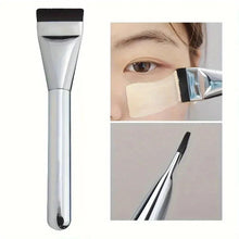 Oval foundation brush with silver handle and black nylon bristles for makeup contouring