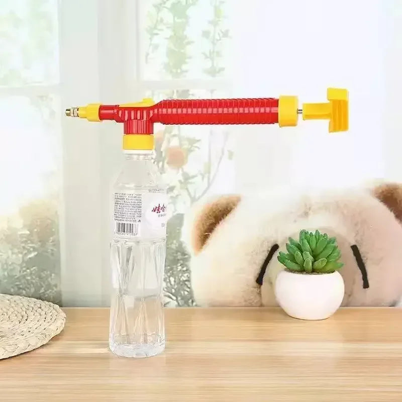 Manual sprayer nozzle attached to a clear bottle with red and yellow control parts