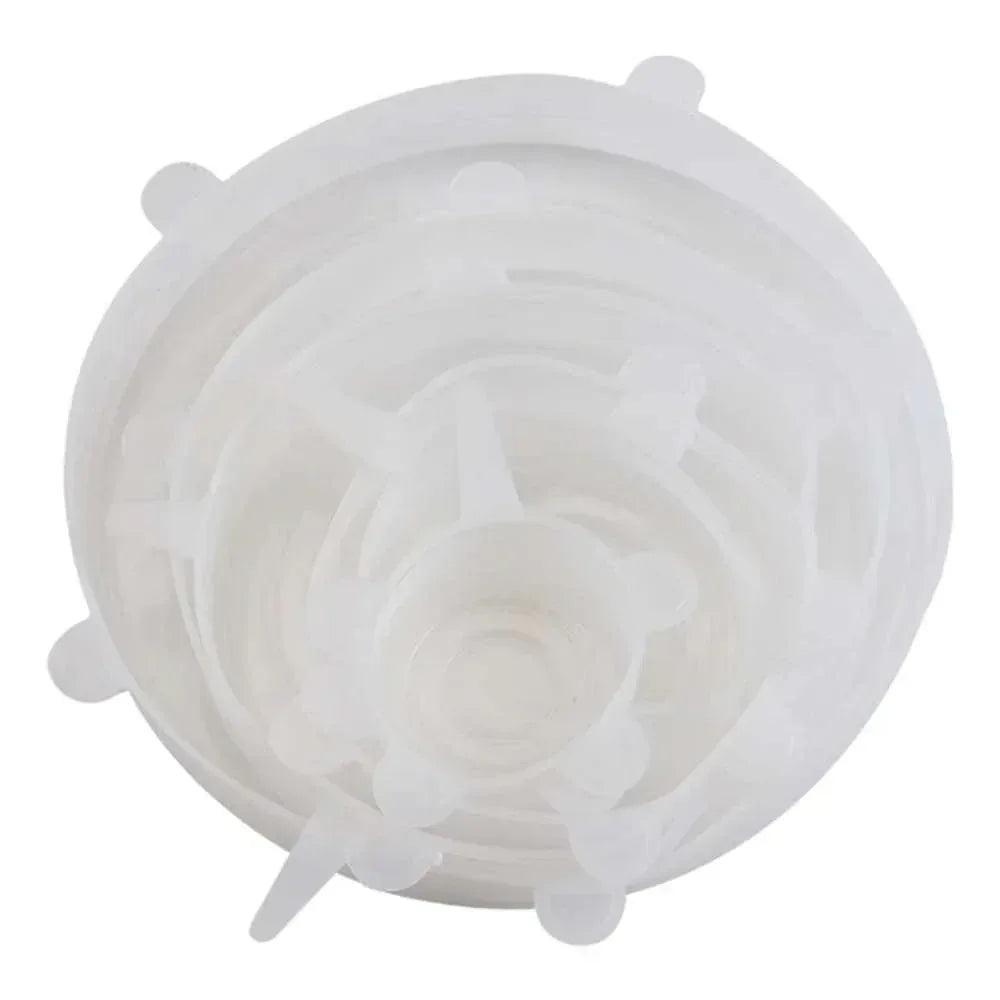 White translucent round silicone stretch lid with raised center and tabs.