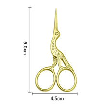 Gold-tone eyebrow and nose hair scissors with ornate handle, round finger loops.