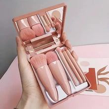 Mini makeup brush set with rose-beige handles in a foldable case with mirror