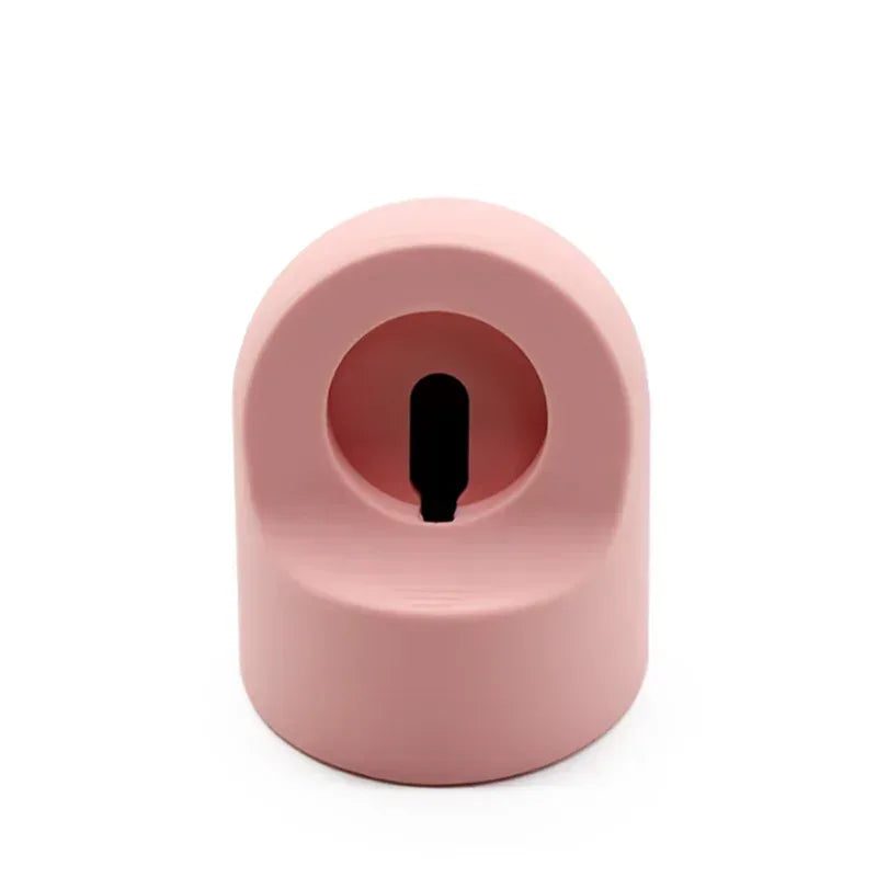 Pink silicone charging stand with central slot for smartwatch charger cable