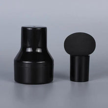 Round head cosmetic puff brush with black handle and dark sponge top