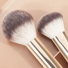 Pair of makeup brushes with cream handles and white-and-gray rounded bristle heads