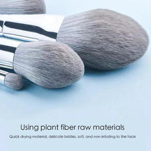 Makeup brushes with silver handles and gray bristles, bristles close-up