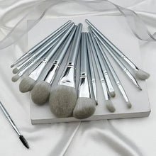 Makeup brush set in tray with silver handles and soft gray bristles