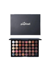 Eyeshadow palette compact open with multicolor shades under a black lid.