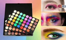 Eyeshadow palette with assorted round pans next to colorful eye makeup swatches