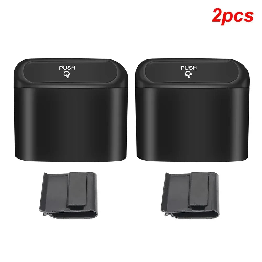 Set of two black push-top mini car trash bins with matching holders