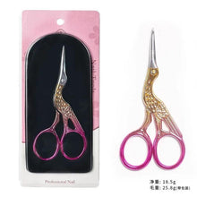 Iridescent nail scissors with pink and purple accents, round finger loops.