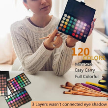 Mini colorful eyeshadow palette with rows of round pans, held open with full-color shades