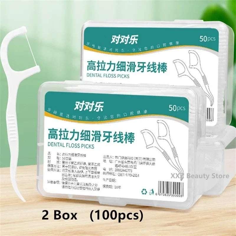 Multiple dental floss pick boxes with teal labels; white picks partially visible