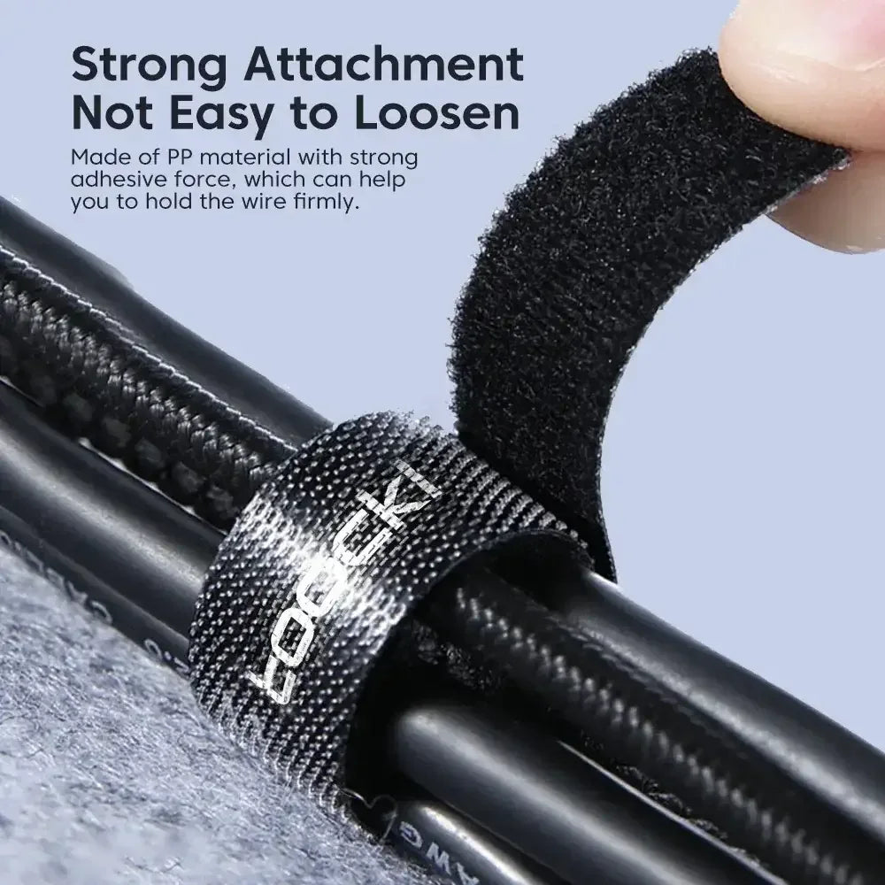 Cable organizer tape securing a cable bundle with loop-and-hook adhesive, black