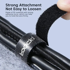 Cable organizer tape securing a cable bundle with loop-and-hook adhesive, black