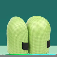 Pair of light green knee pads with black elastic straps