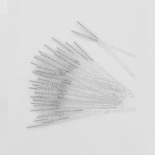 Clear and white disposable eyelash mascara wands with comb-like bristles