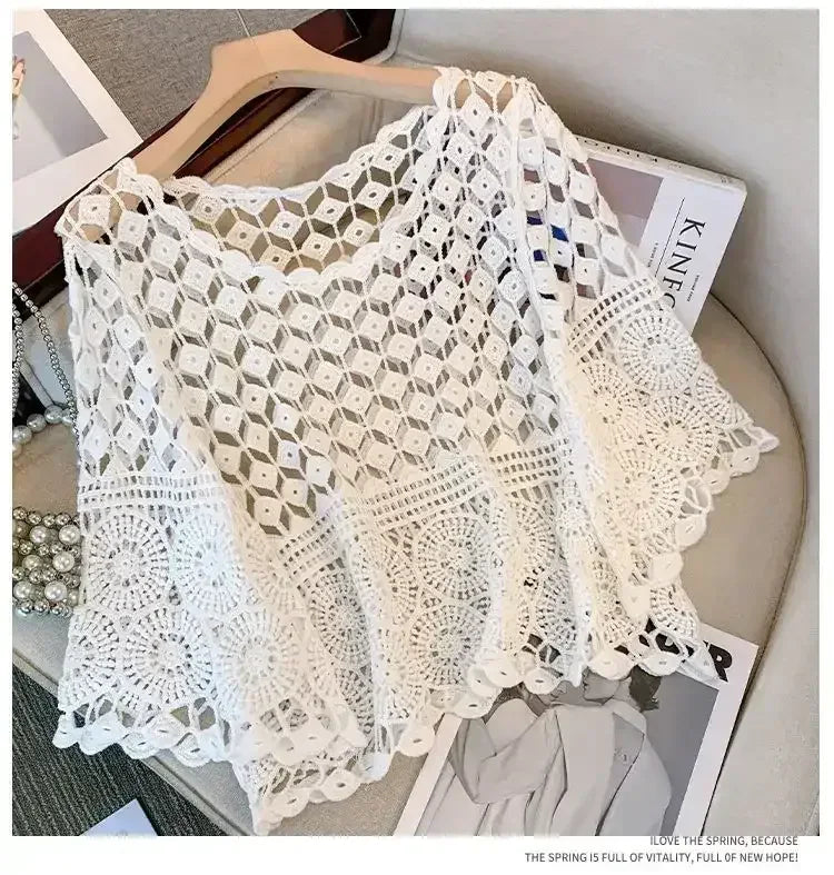 White crochet lace cover-up top with open geometric pattern and scalloped sleeve edges