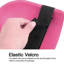 Pink knee pad close-up with black Velcro strap on textured surface.