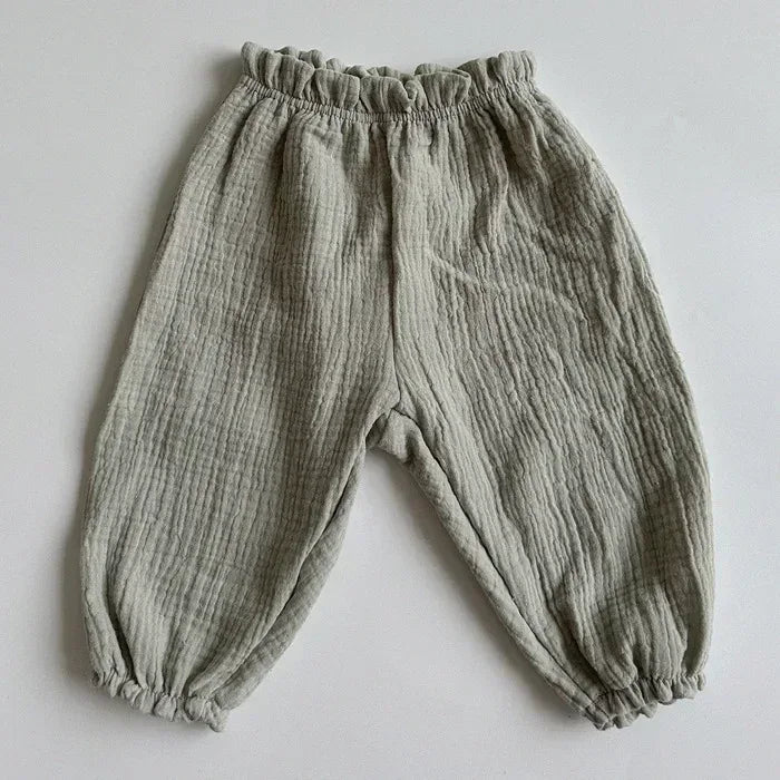 Gray textured muslin baby pants with elastic waist and gathered ankle cuffs