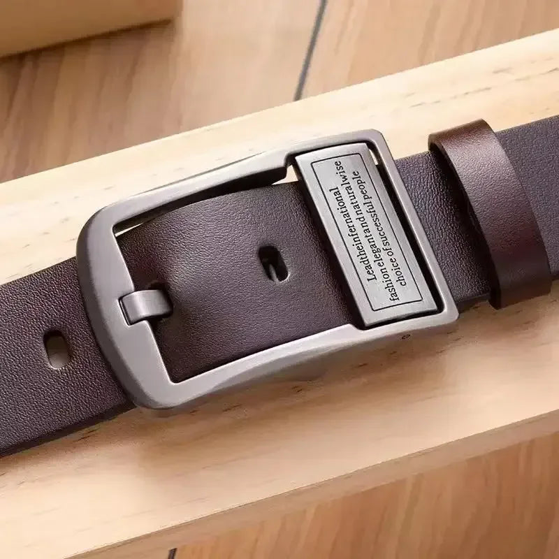 Men's dark brown leather belt with silver rectangular pin buckle on a shelf