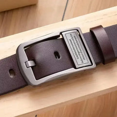 Men's dark brown leather belt with silver rectangular pin buckle on a shelf