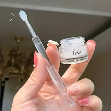 Silicone makeup brush with white oval tip, clear protective cover, and chrome handle