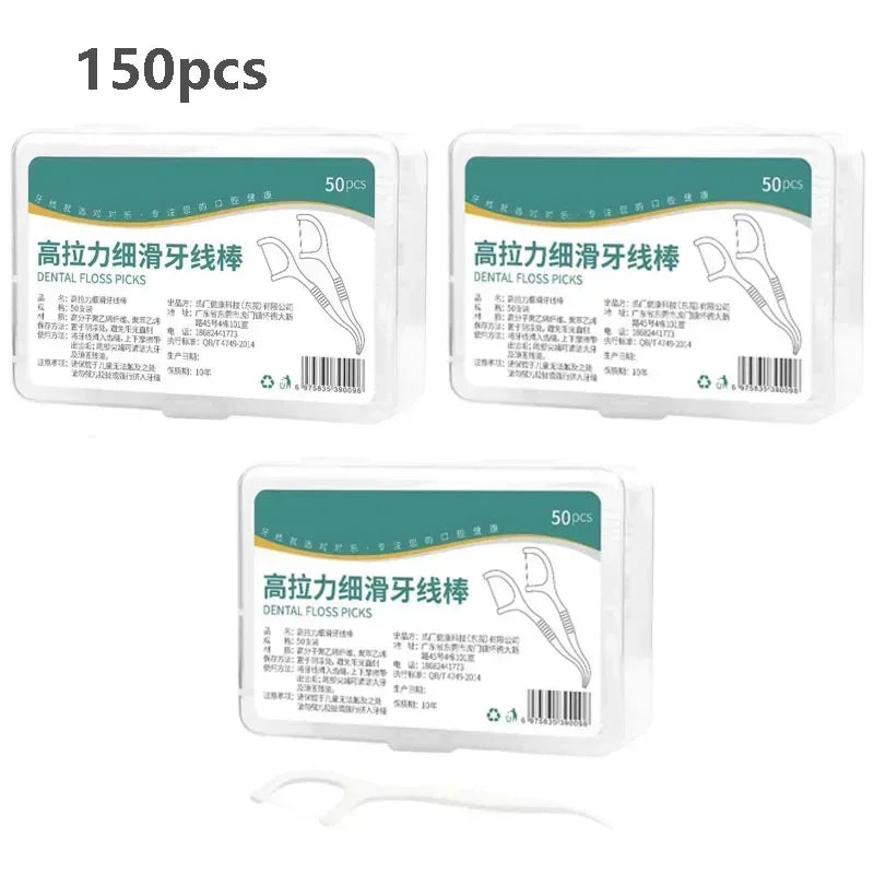 Three dental floss pick boxes with teal labels; single white pick handle shown