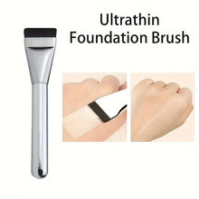 Ultrathin foundation brush with silver handle and black bristles, ready for even coverage
