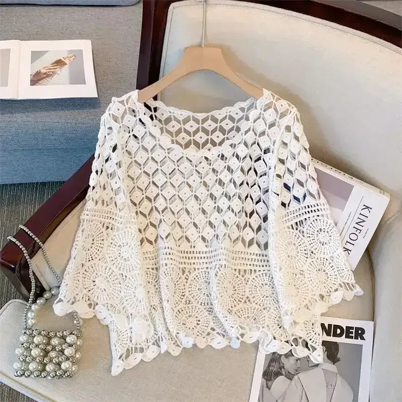 White crochet lace half-sleeve top on hanger with scalloped neckline and hem