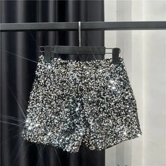 Silver sequined shorts with all-over shiny sparkle and scalloped hem