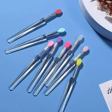 Set of silicone makeup applicator brushes with colored oval tips and chrome handles