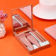 Mini makeup brush set with rose-beige bristles stored in a compact case
