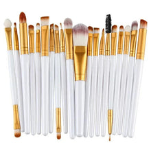 Eye makeup brush set with white handles and gold ferrules, including a spoolie brush