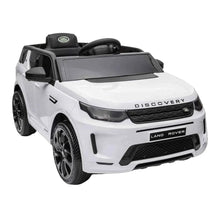 White electric ride-on SUV close-up front with steering wheel and black grille