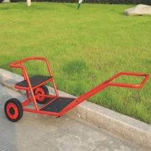 Red tricycle-style wagon with black seat and flatbed, shown on concrete walkway