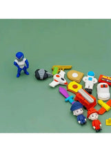 Toy-like character eraser lineup with small accessory pieces on white shelf