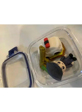 Lunch box-shaped eraser with astronaut and small rocket figure in clear compartment