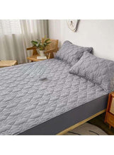 Quilted dark grey fitted bedding topper with matching pillow