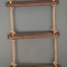 Wooden rungs and beige rope side rails on a rope ladder, close-up