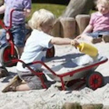 Red and gray kids wheelbarrow with black wheel and long handles