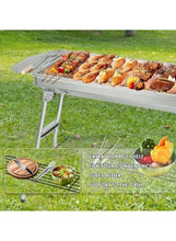 BBQ grill on grass with roasted kebabs on the upper grate and storage shelf below