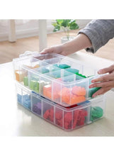 Translucent three-tier storage box open with colorful organizers inside
