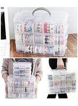 Translucent three-tier storage box with gray carry handle, holding spools and trim