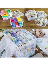 Translucent three-tier storage box with gray handle containing small craft pieces