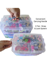 Three-tier translucent storage box being carried by its gray handle