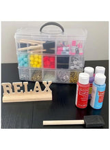 Translucent three-layer storage box with handle holding small craft supplies