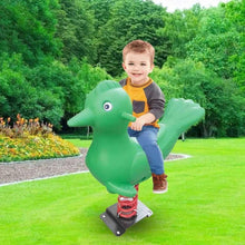 Child sitting on green bird-shaped spring rider with red coil spring and black base
