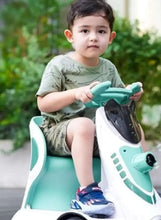 Kids electric car, white-and-green body with open front and seat; child riding