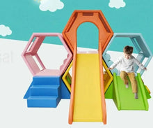 Indoor soft play slide set with yellow slide, blue steps, green platform, and hexagon openings