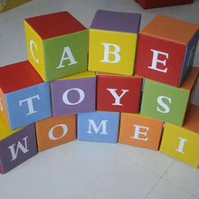 Foam alphabet cubes with printed letters, arranged in an open ring